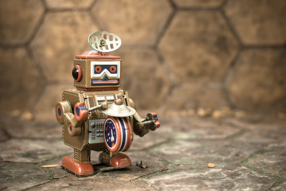 Old robot toy, vintage color style, vintage tone background.